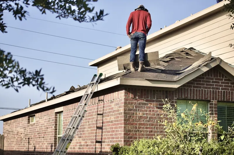 Professional roofer working on a residential roof in Lorena